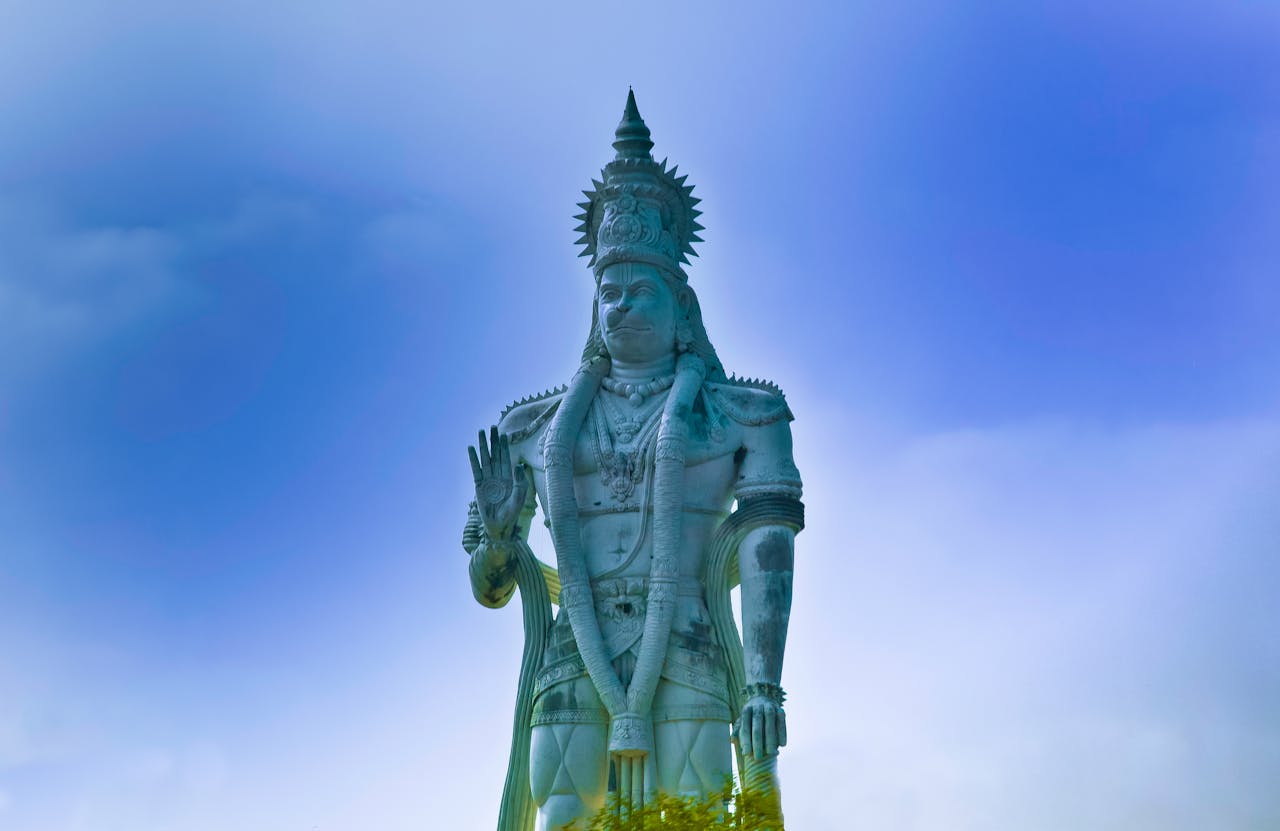 Hanuman statue beneath a blue sky
